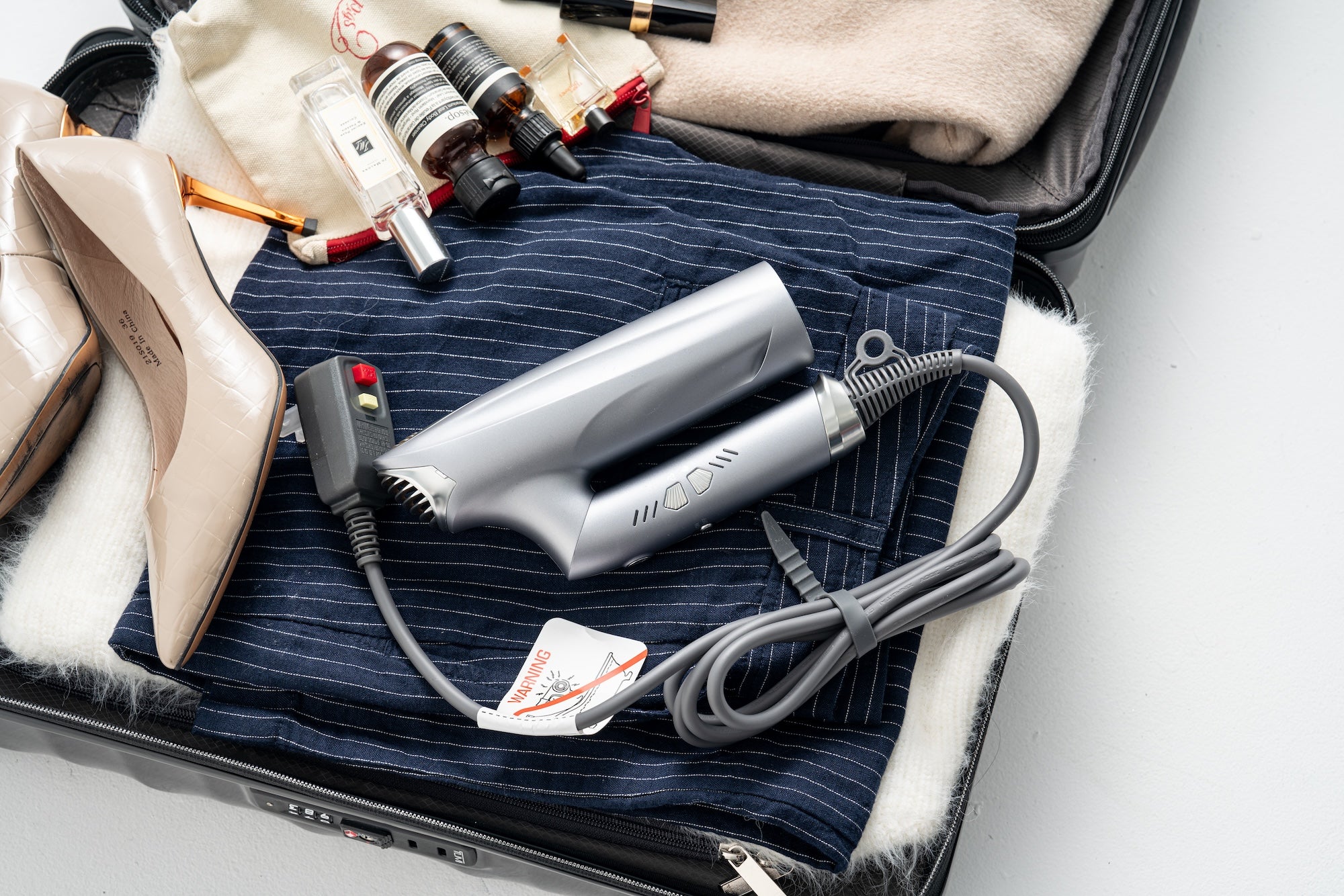 best foldable and travel hair dryer 2024 - VENTRIS BlitzFlow High Speed Hair Dryer in a luggage.